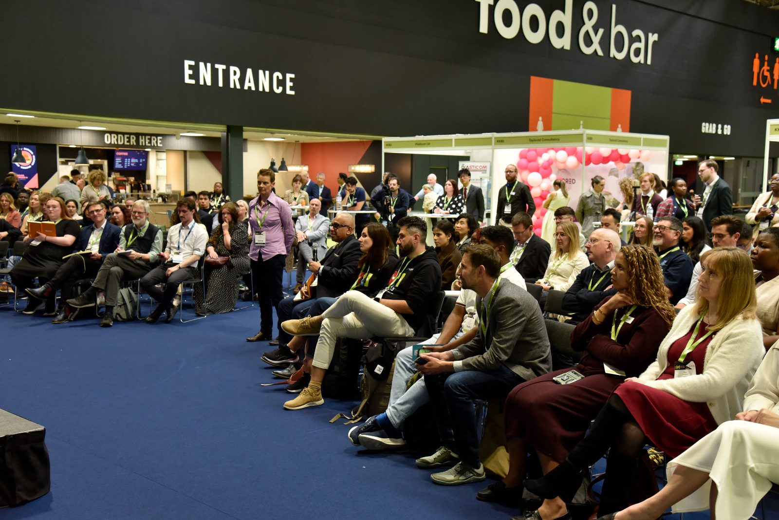 An exhibitor pitching to visitors on their stand